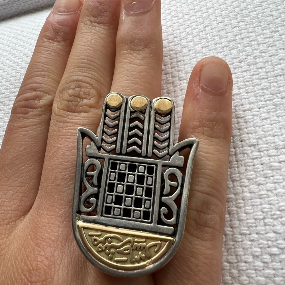 One-of-a-kind 18-k gold and sterling silver protective ring.